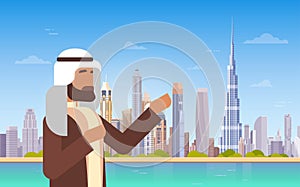 Arab Man Showing Dubai Skyline Panorama, Modern Building Cityscape Business Travel And Tourism Concept