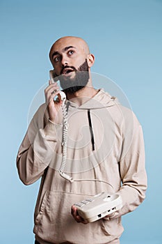 Arab man speaking on corded phone