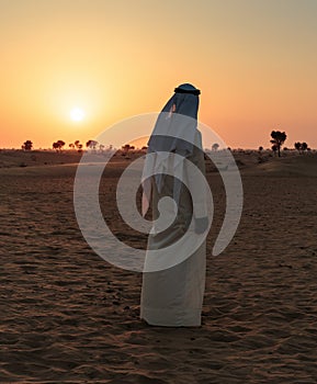 Arab man stands alone in the desert