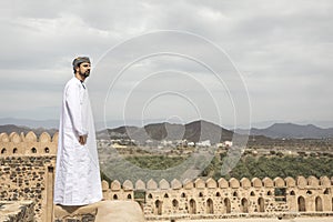 Arab man in traditional omani outfit in an old castle