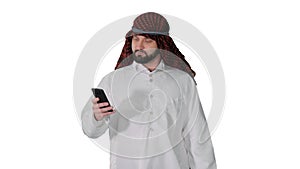 Arab man using his smartphone surfing on the internet or messagi