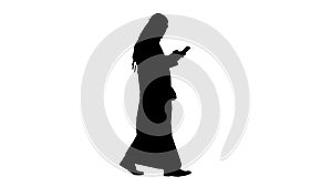 Arab man using his smartphone surfing on the internet or messagi