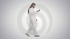 Arab man using his smartphone surfing on the internet or messagi