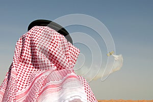 Arab man watching airshow photo