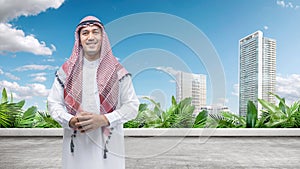 Arab man wearing keffiyeh and agal standing in the city photo