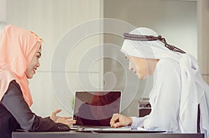 Arab middle eastern woman presented the report to the manager. Woman pointing into laptop computer monitor