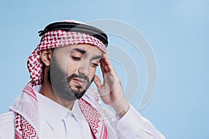 Arab with migraine expressing discomfort