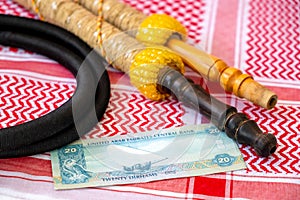 Arab Money Dirham Banknote, hookah and Traditional Arab Male Clothes - kaffiyah and agal  close-up photo