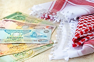 Arab Money Dirham Bank notes  and Traditional Arab Male Scarf - kaffiyah  close-up photo