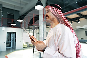 Arab muslim businessman using digital tablet in modern office