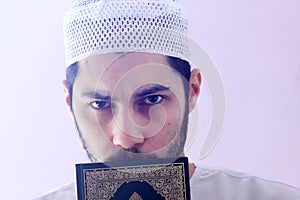 Arab muslim man with koran holy book