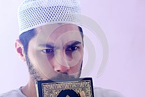 Arab muslim man with koran holy book