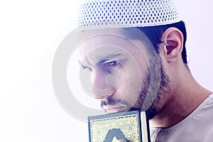 Arab muslim man with koran holy book