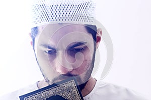 Arab muslim man with koran holy book