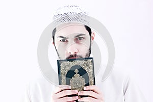 Arab muslim man with koran holy book