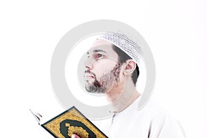 Arab muslim man with koran holy book