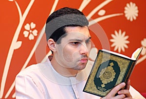 Arab muslim man with koran holy book