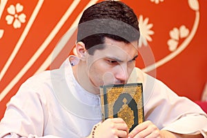 Arab muslim man with koran holy book