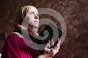 Arab muslim woman with koran holy book