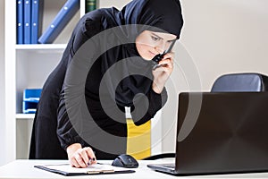 Arab office worker using laptop