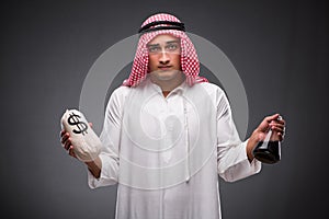 The arab with oil on gray background