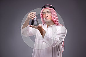 The arab with oil on gray background