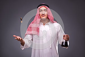 The arab with oil on gray background