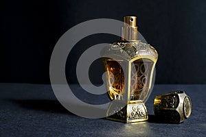Arab perfume in a bottle, isolated in black background, in low l