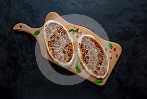 Arab pizza on a wooden stand. Scones with minced meat and pomegranate.