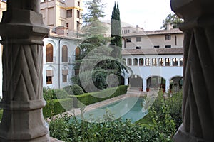 Arab pool of the courtyard of the Alcazar minor with the cloister of the Monastery in front photo