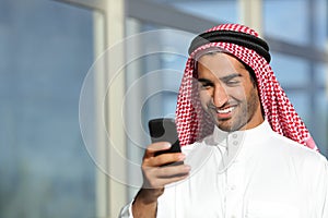 Arab saudi businessman working with his phone photo