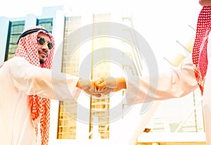 Arab saudi emirates businessman giving fist bump after complete