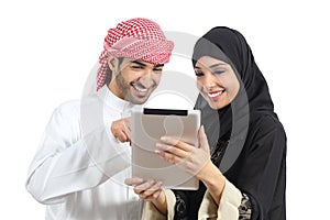 Arab saudi happy couple browsing a tablet reader photo