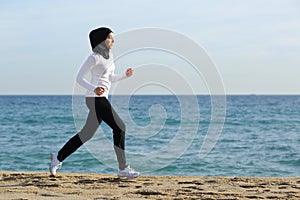 Arab saudi runner woman running on the beach