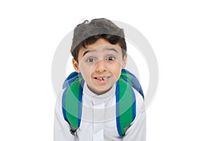 Arab school boy closeup on face with a smile and broken tooth, wearing white traditional Saudi Thobe, back pack and sneakers, photo