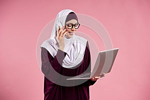Arab smart woman in hijab speaks on smartphone