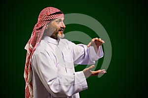 Arab sorcerer forming energy ball with his hands, performs mystical ritual. Mystical and supernatural aspects of