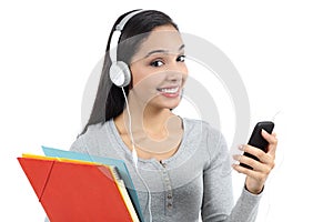 Arab student listening to the music and holding folders