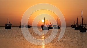 Arab traditional dhows in the shore during the sunrise in Qatar