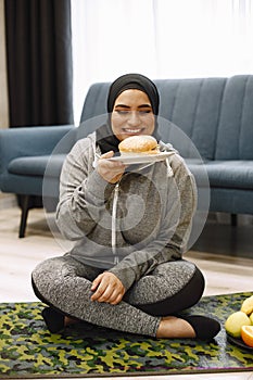 Arab woman choosing between healthy and unhealthy eating.