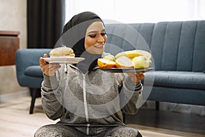 Arab woman choosing between healthy and unhealthy eating.
