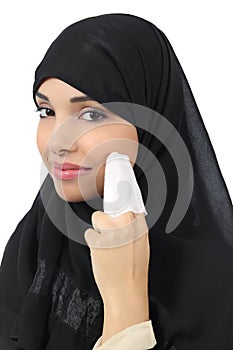 Arab woman cleaning her face with a baby wipe
