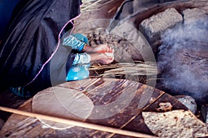 Arab woman makes bread in the beduin village in Egypt