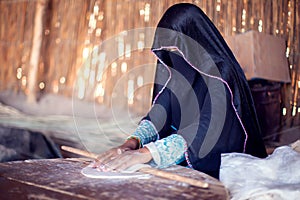 Arab woman makes bread in the beduin village in Egypt