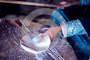 Arab woman makes bread in the beduin village in Egypt