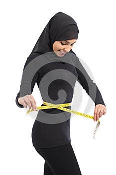 Arab woman measuring waist with a measure tape