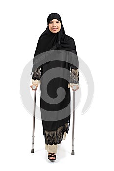 Arab woman walking with crutches