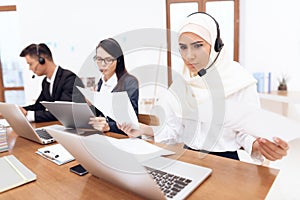 An Arab woman works in a call center.