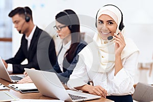 An Arab woman works in a call center.