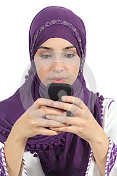 Arab woman writing a message addicted to the smart phone